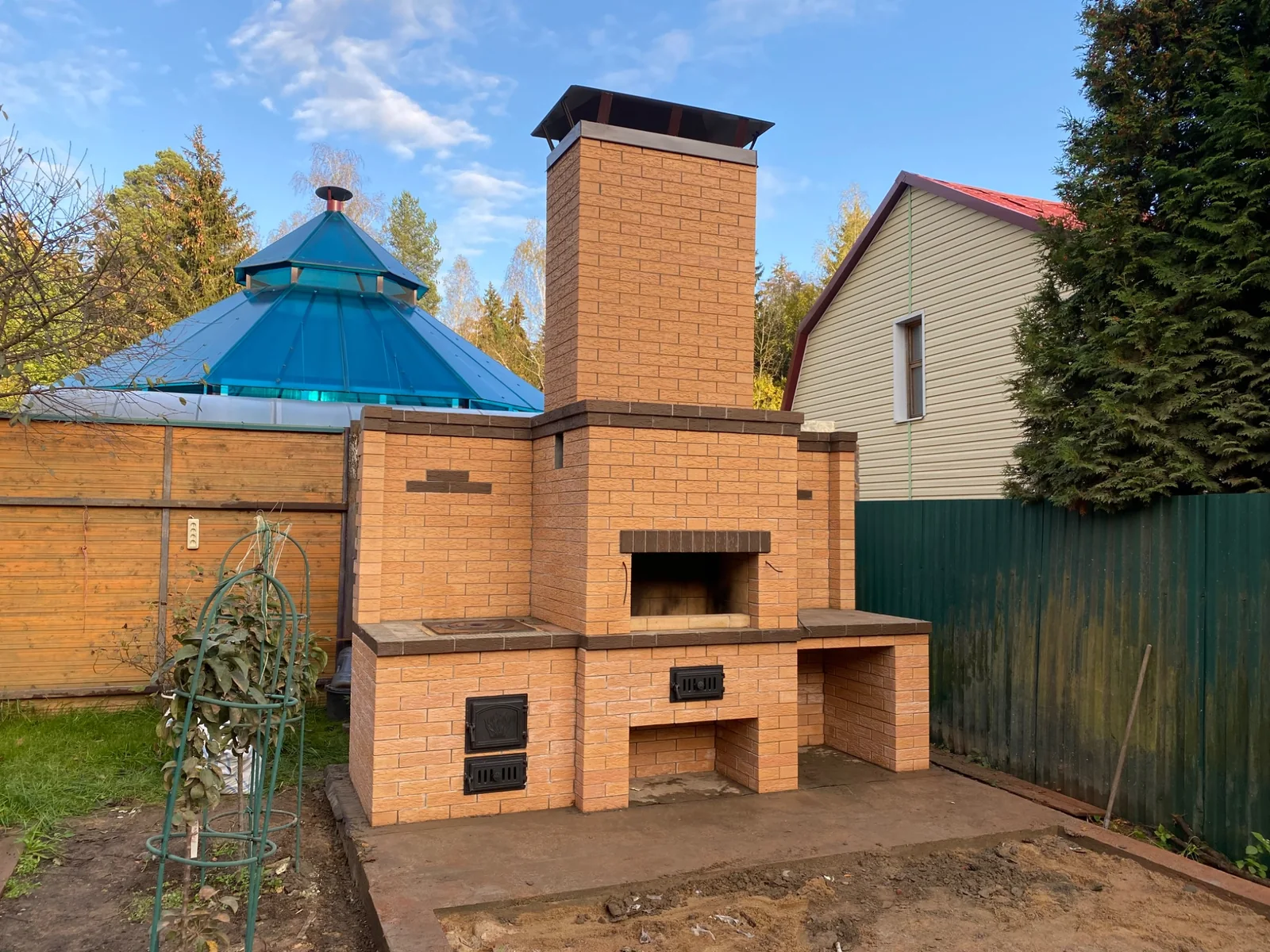 Кирпичный барбекю-комплекс с мангалом и рабочими зонами во дворе